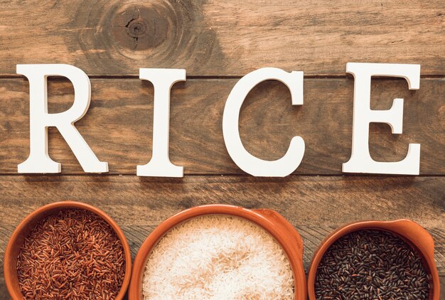 White rice text with bowl of rice on wooden table