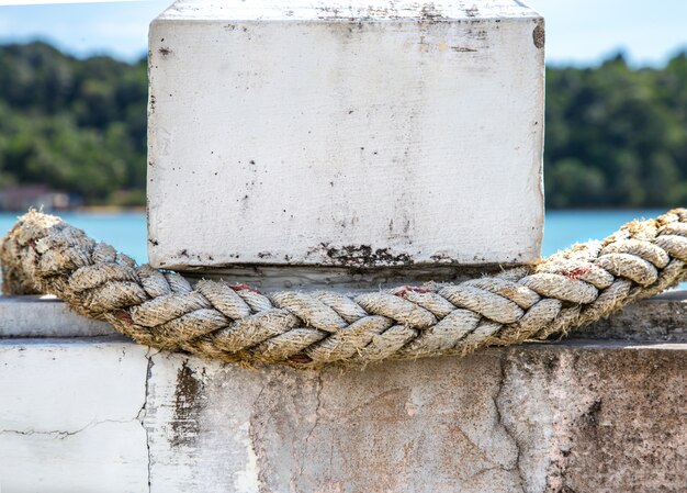 white rope closeup, tied to the pier