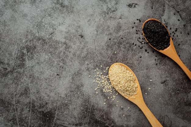 White sesame and black sesame on dark background