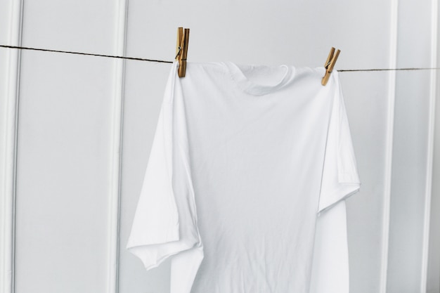 Белая рубашка висит у стены