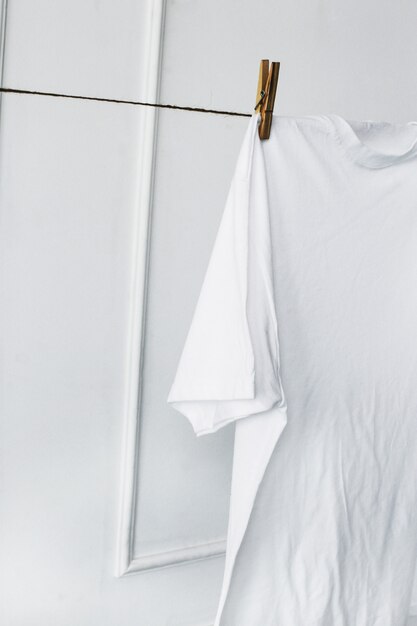 White shirt hanging by the wall