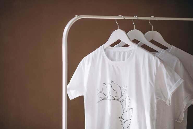 Free Photo white shirts hanging in room