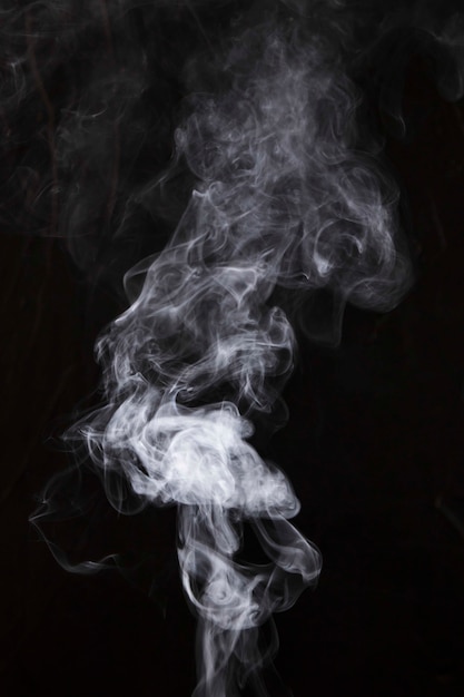 White smoke fragments on black background