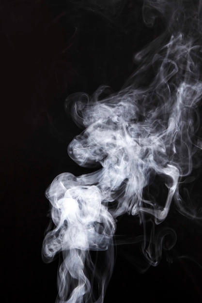 White smoke spread on black background