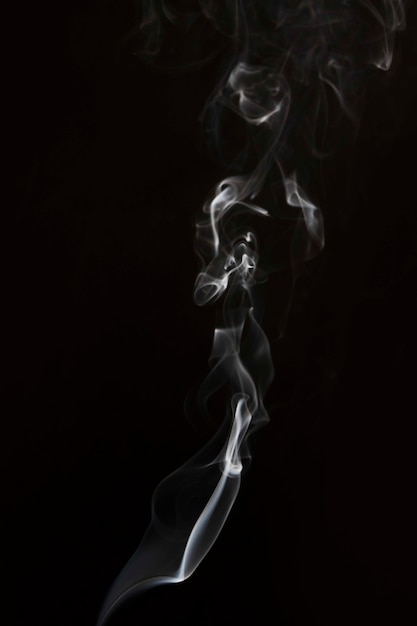 Free photo white smoke swirl pattern against black backdrop