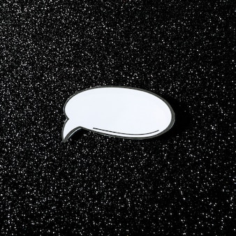 White speech bubble on sparkling black background