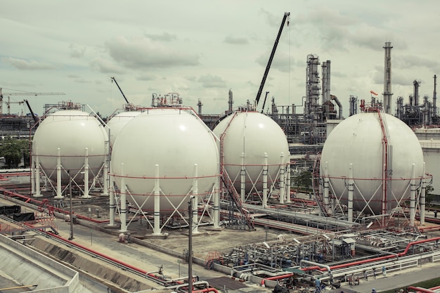 White spherical propane tanks containing fuel gas pipeline and scaffolding work