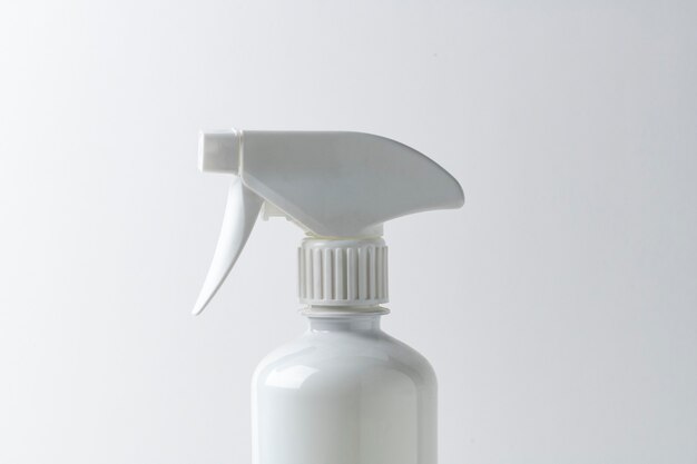 White spray bottle on a plain surface