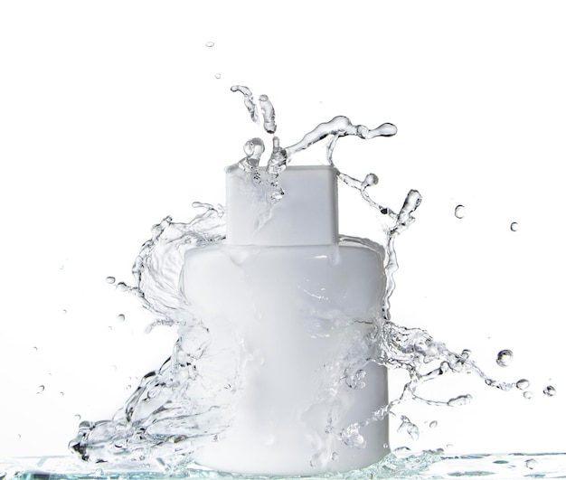 White square glass bottle on white background and splashing water