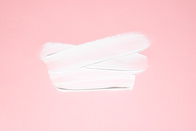 White strokes of paint on pink