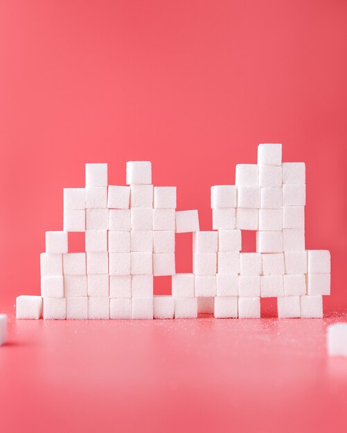 White sugar cubes composition on red