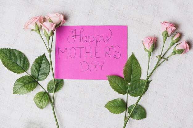 White surface with card between flowers