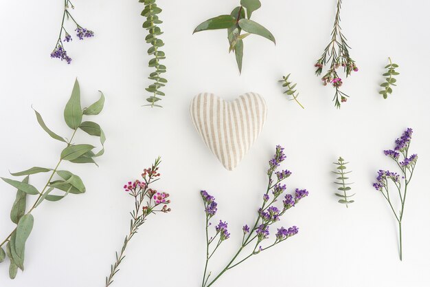 White surface with flowers and striped heart