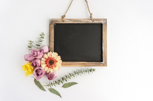 White surface with slate and flowers