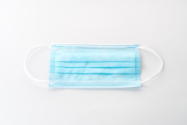 White surgical mask on blue background