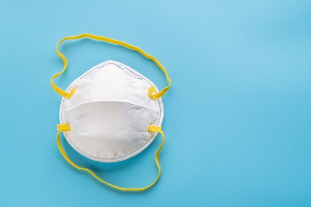 White surgical mask on blue background