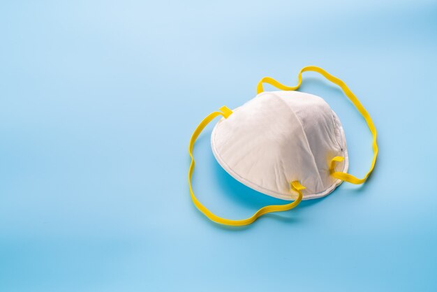 White surgical mask on blue background