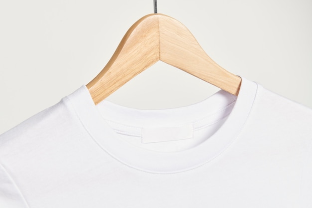 White t-shirt on a wooden hanger