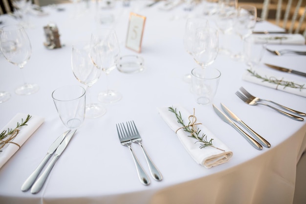 White table setting at wedding reception venue.