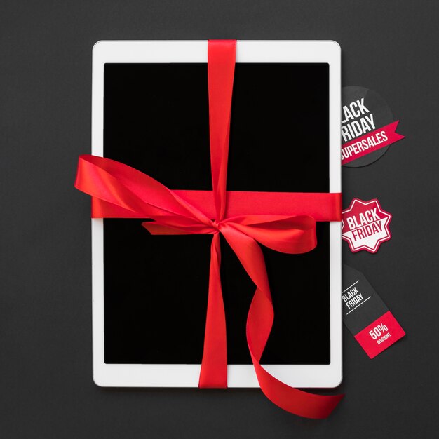 White tablet with ribbon near sale stickers