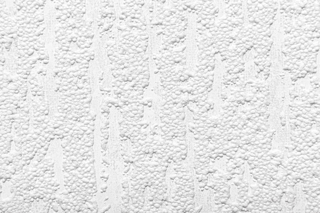 Белая текстурированная стена как предпосылка.