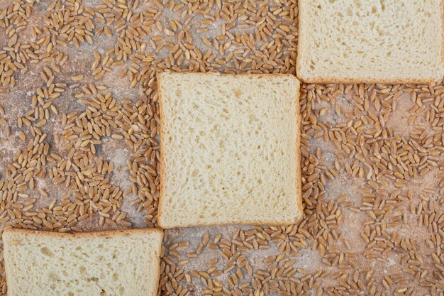 White toast slices with barley on marble background