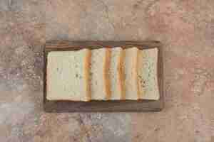 Free photo white toast slices on wooden board