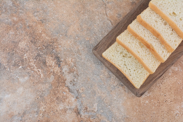 White toast slices on wooden board