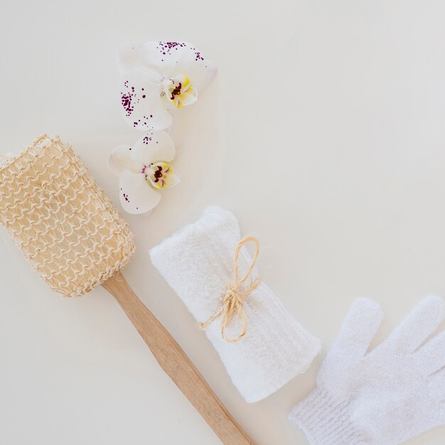 White towel brush and orchid flower for skin care