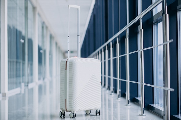 White travel bag isolated alone by the gates