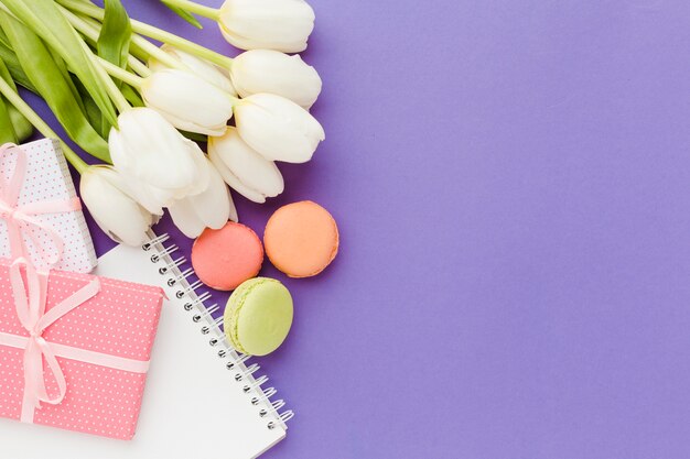 White tulip flowers and sweets flat lay