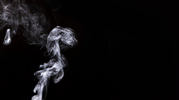 White twirling smoke on black background