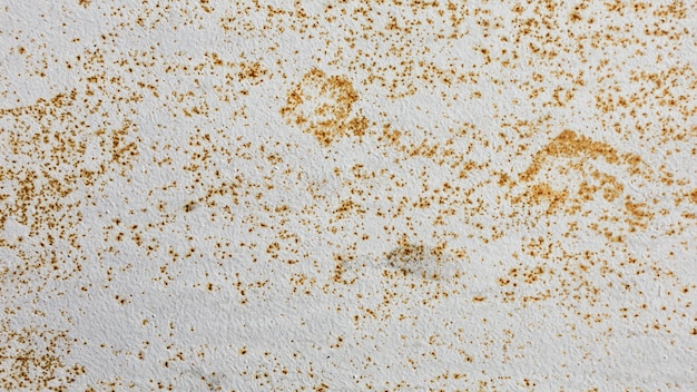 White wall with golden grungy stains texture