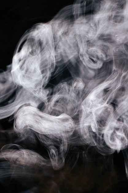 White wavy smoke on black background