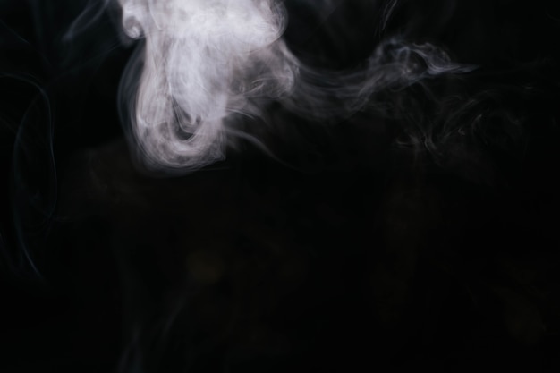 White wavy smoke on black background