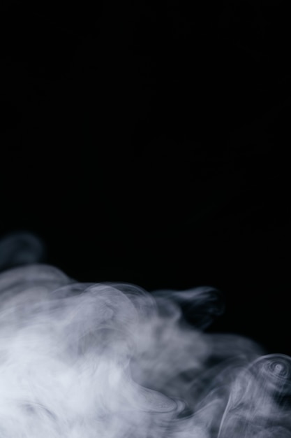 Free photo white wavy smoke on black background