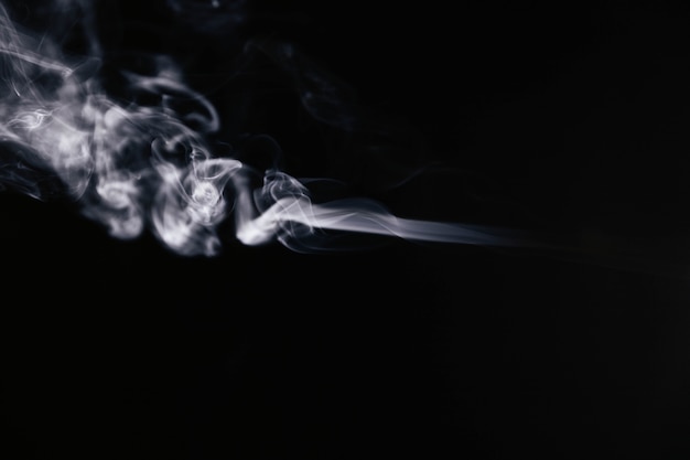 White wavy smoke on black background