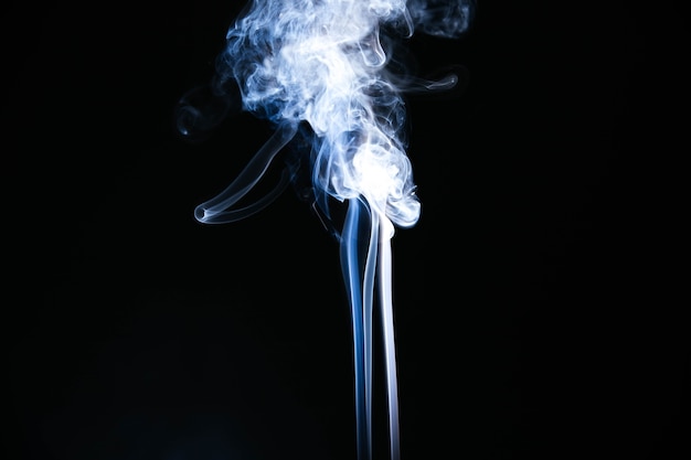 Free photo white wavy smoke on black background