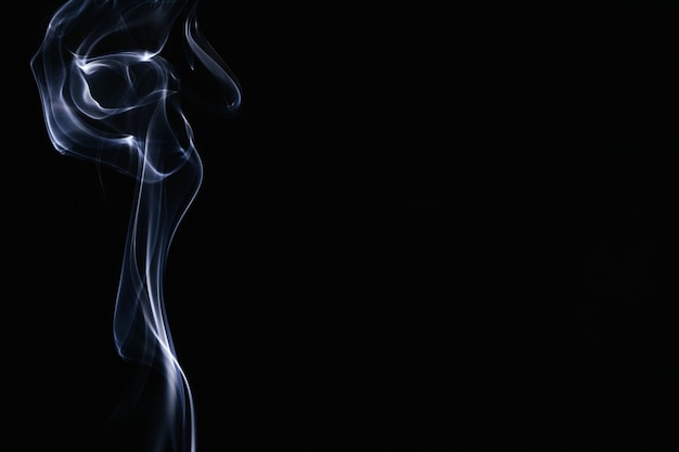 White wavy smoke on black background