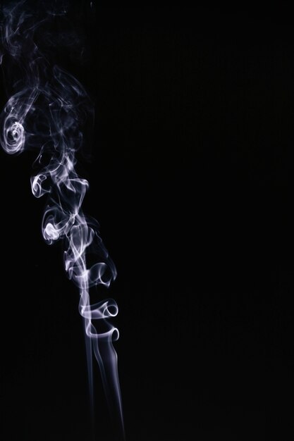 White wavy smoke on black background