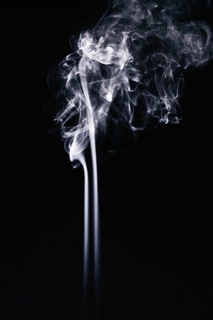 White wavy smoke on black background