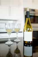 Free photo white wine bottle on the kitchen table