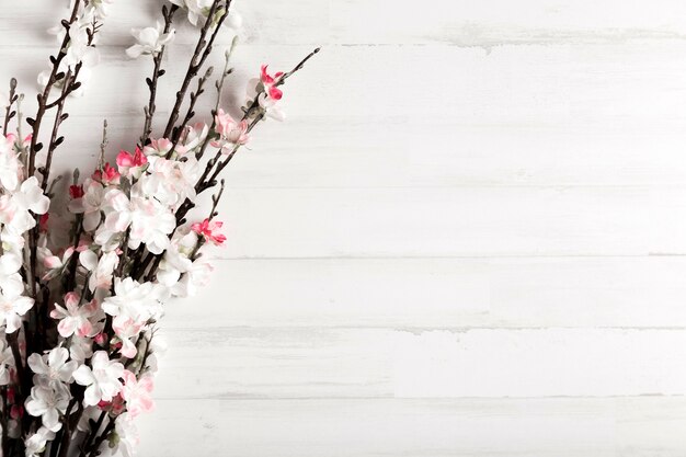 White wooden background with flowers