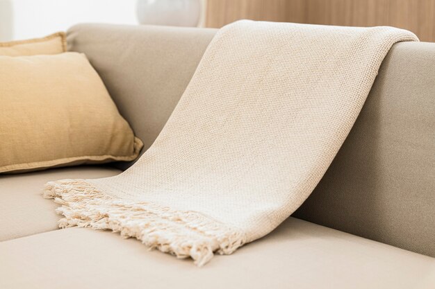 White woven throw blanket on sofa