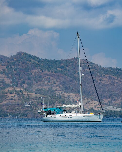 White yacht with mountains. 