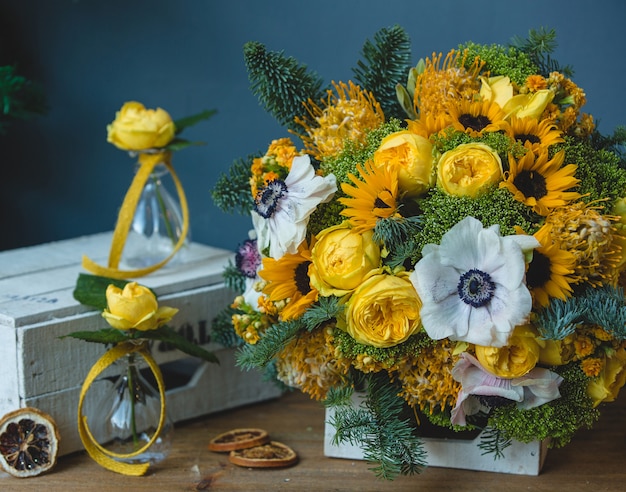 白黄色の花の花束と周りの小さなフラスコの花瓶