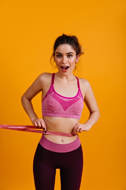 White young woman measuring her waiste