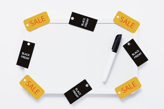 Free Photo whiteboard with black friday tags and marker