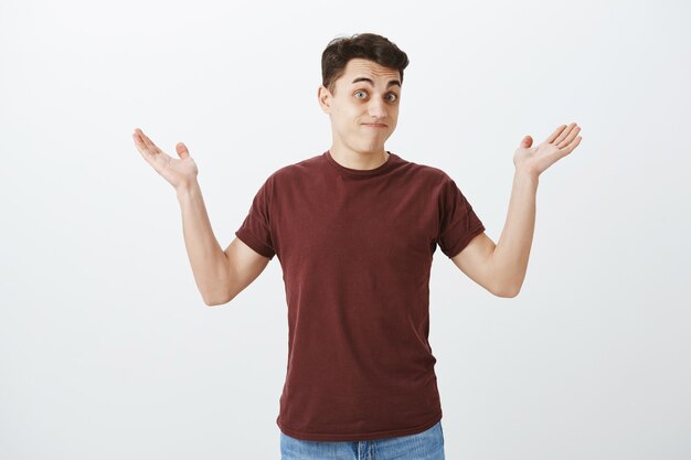 Who knew it happen. Portrait of clueless unaware attractive man in red t-shirt