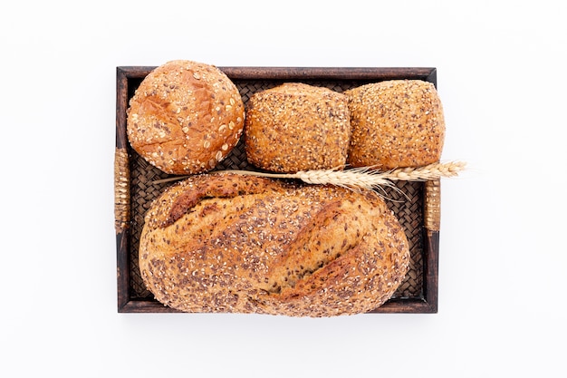 Whole bread and small buns on a basket